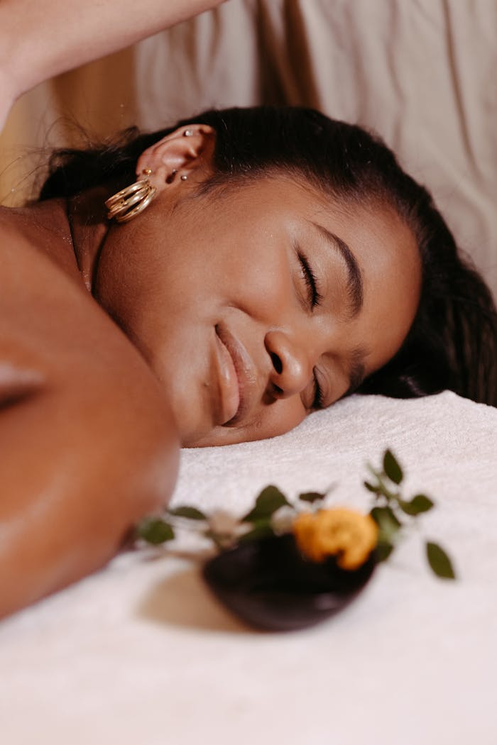 mobile-01 Woman enjoying a relaxing massage at a spa with serene ambiance and aromatherapy.